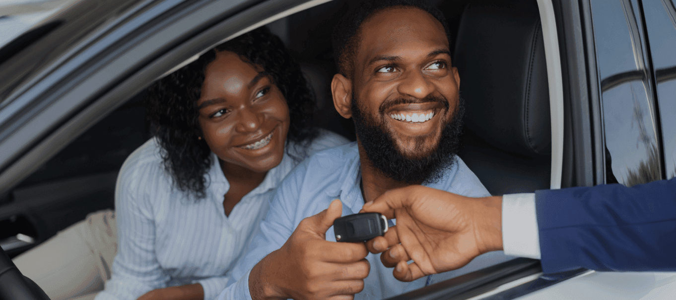 Happy couple receiving car keys